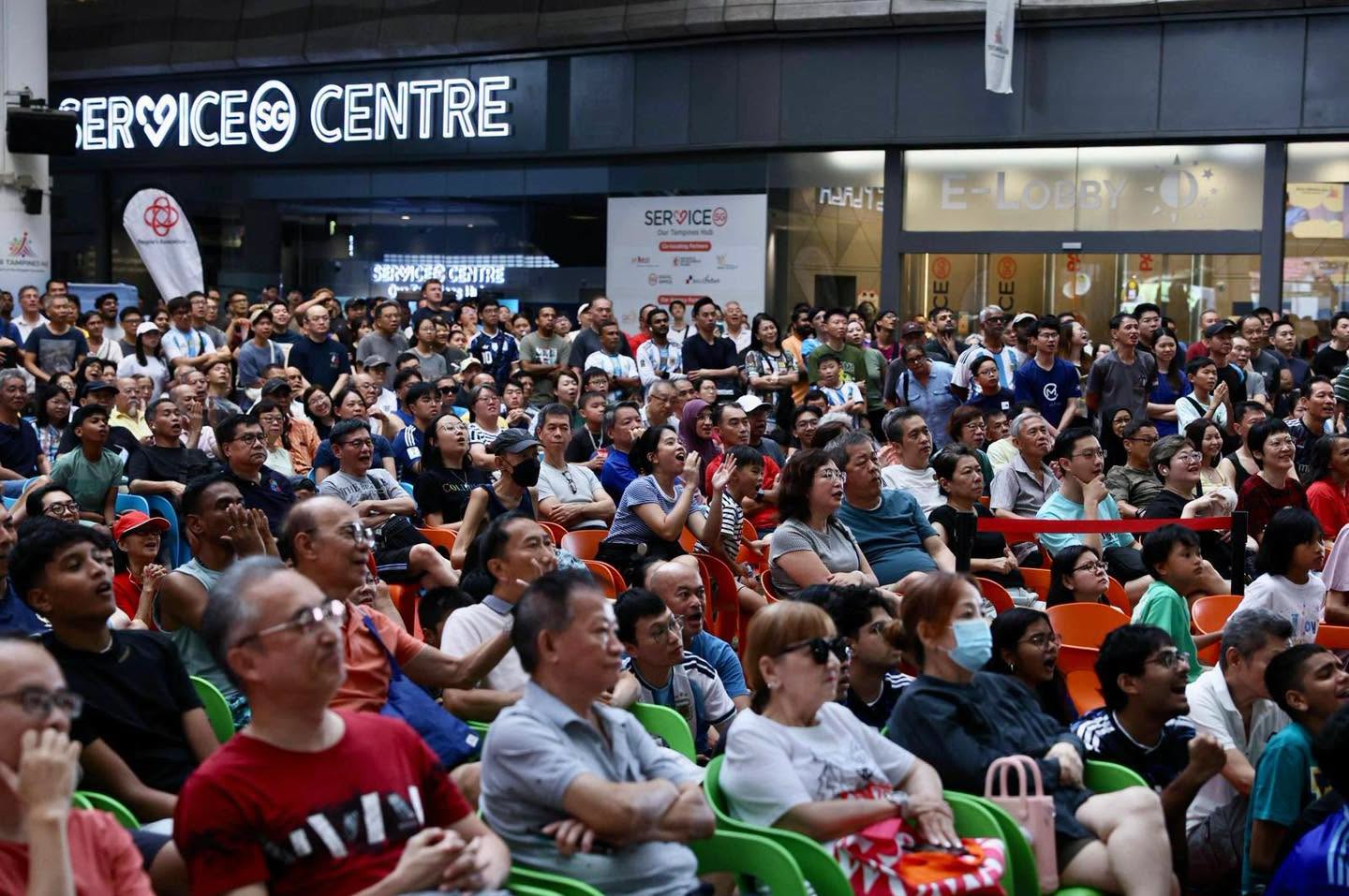 Crowd seated at Service SG Centre near E-Lobby during live screening