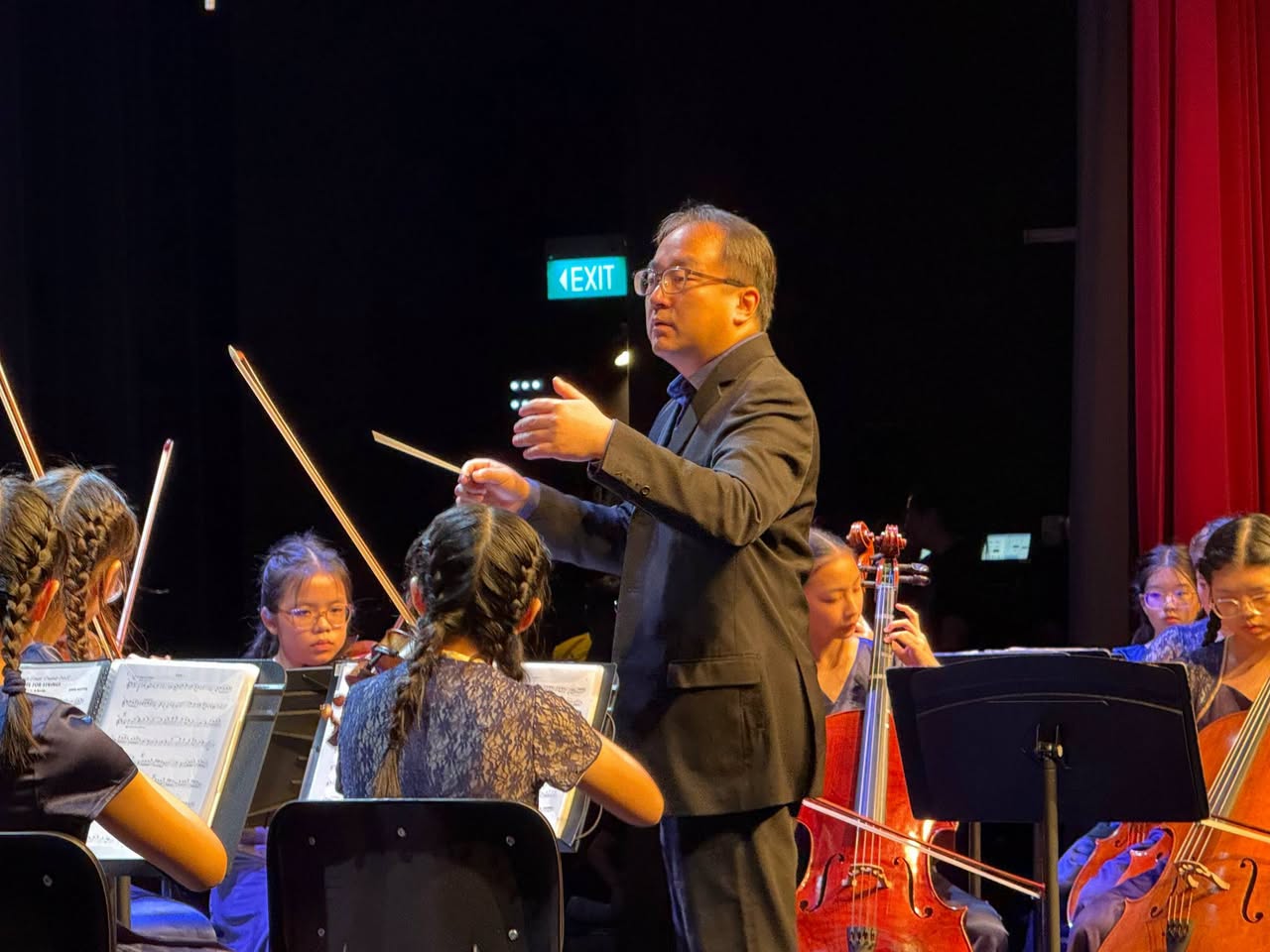 Orchestra performing on stage at an indoor venue