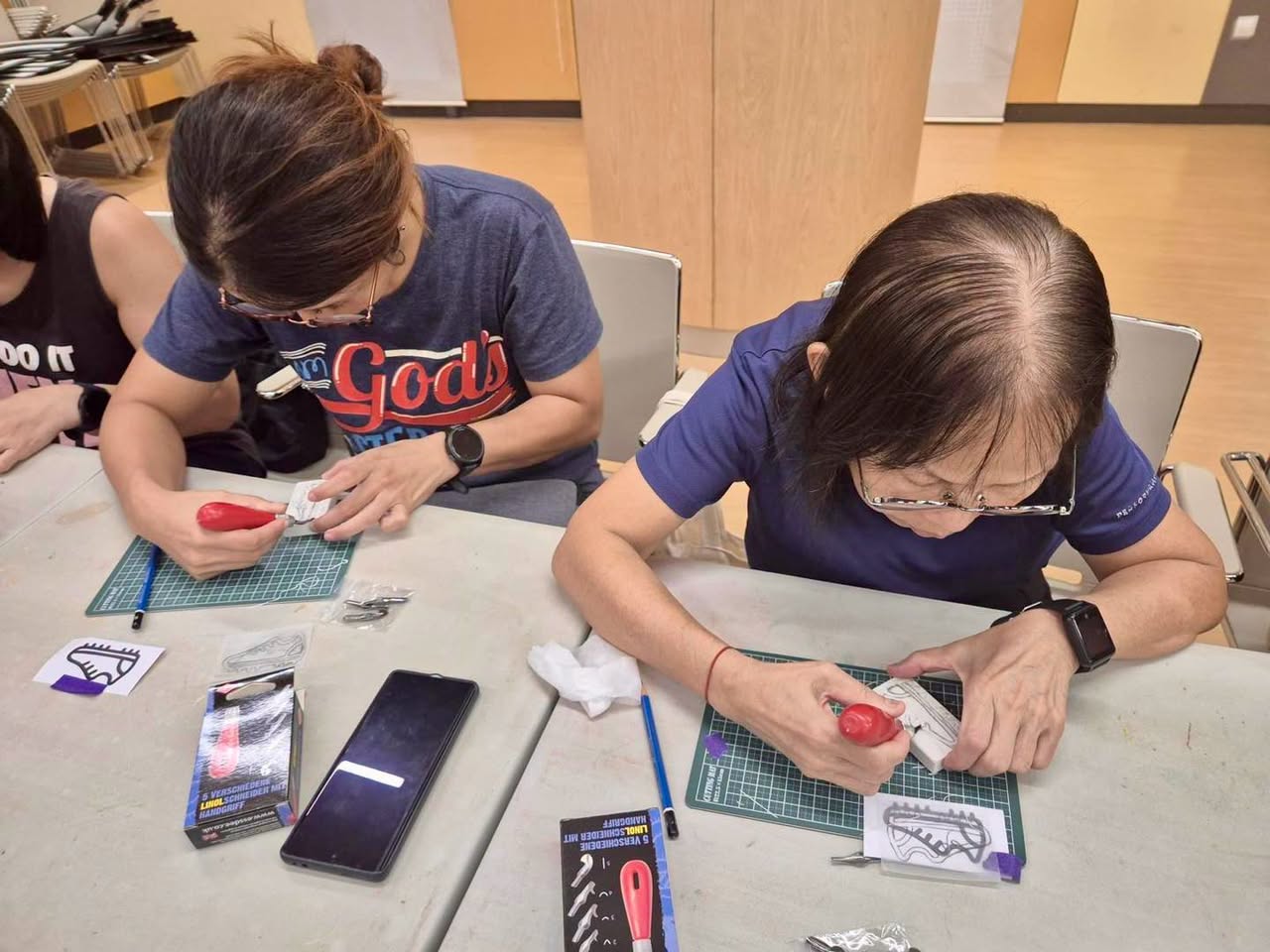 Workshop participants working with tools at crafting tables