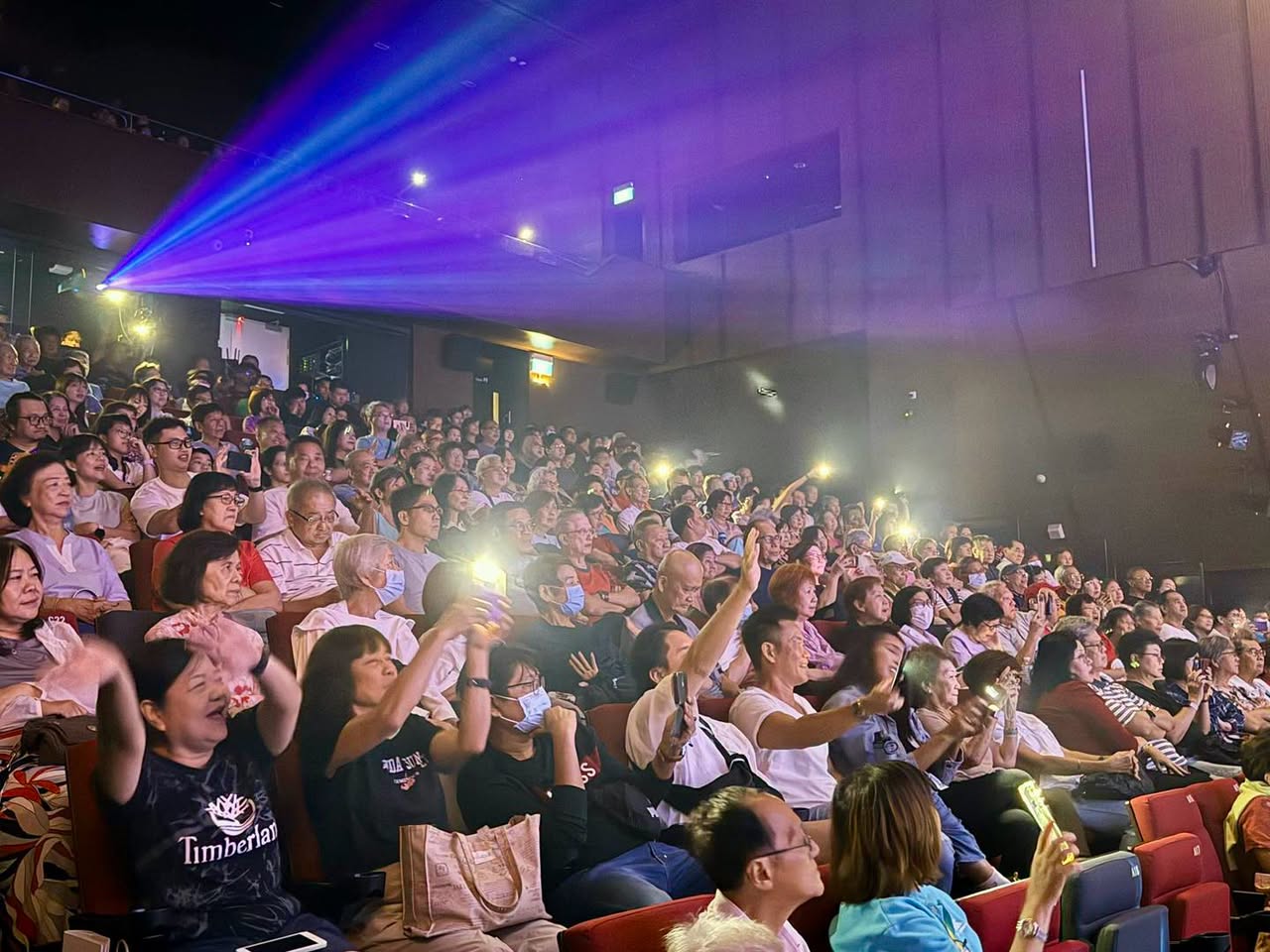 Audience at Bon Jovi tribute concert with phone flashlights raised