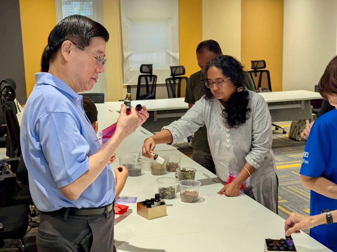 Participants handling vials and plant samples at the workshop