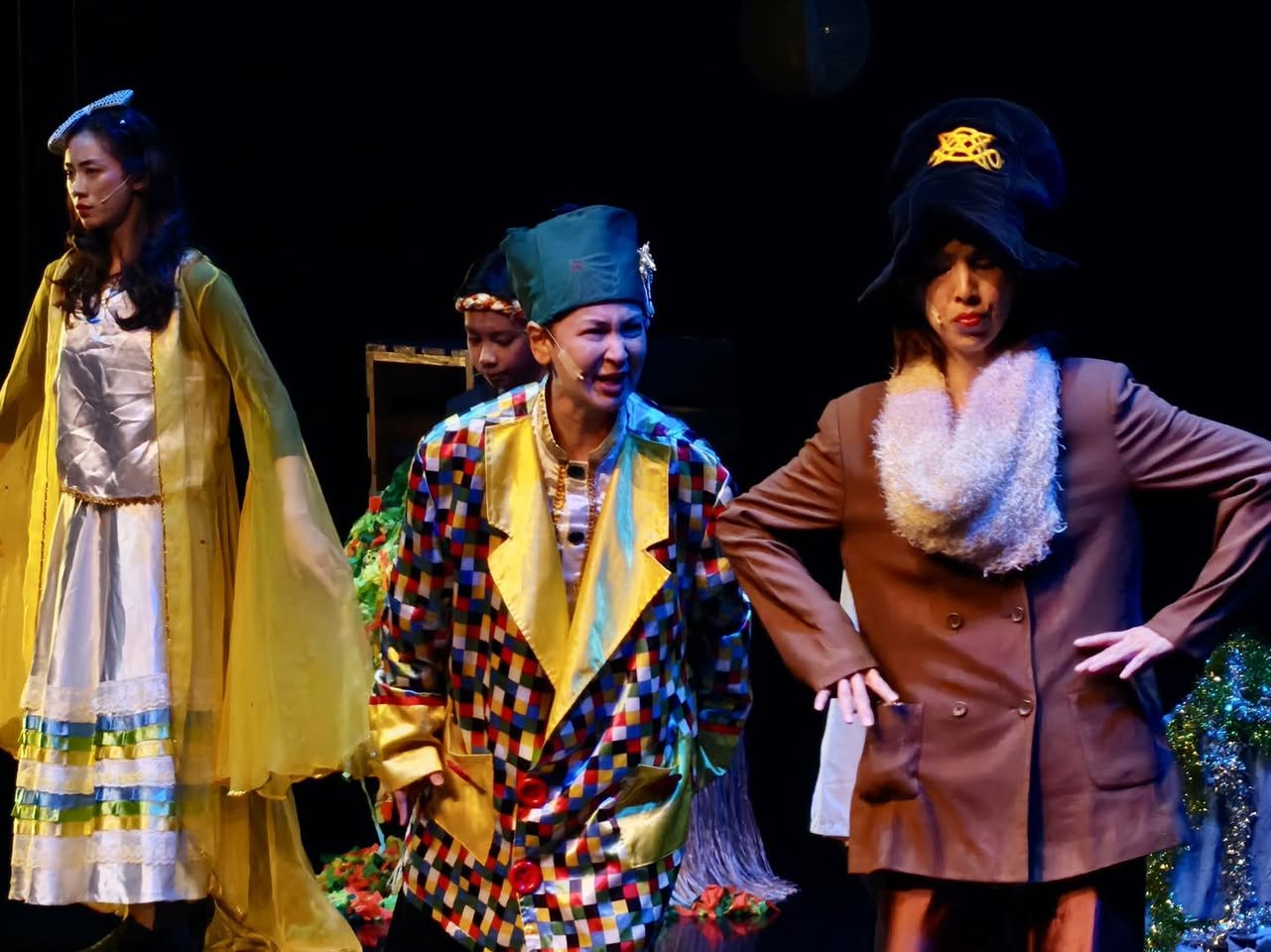 The cast of 'Scrooge' interacting on stage