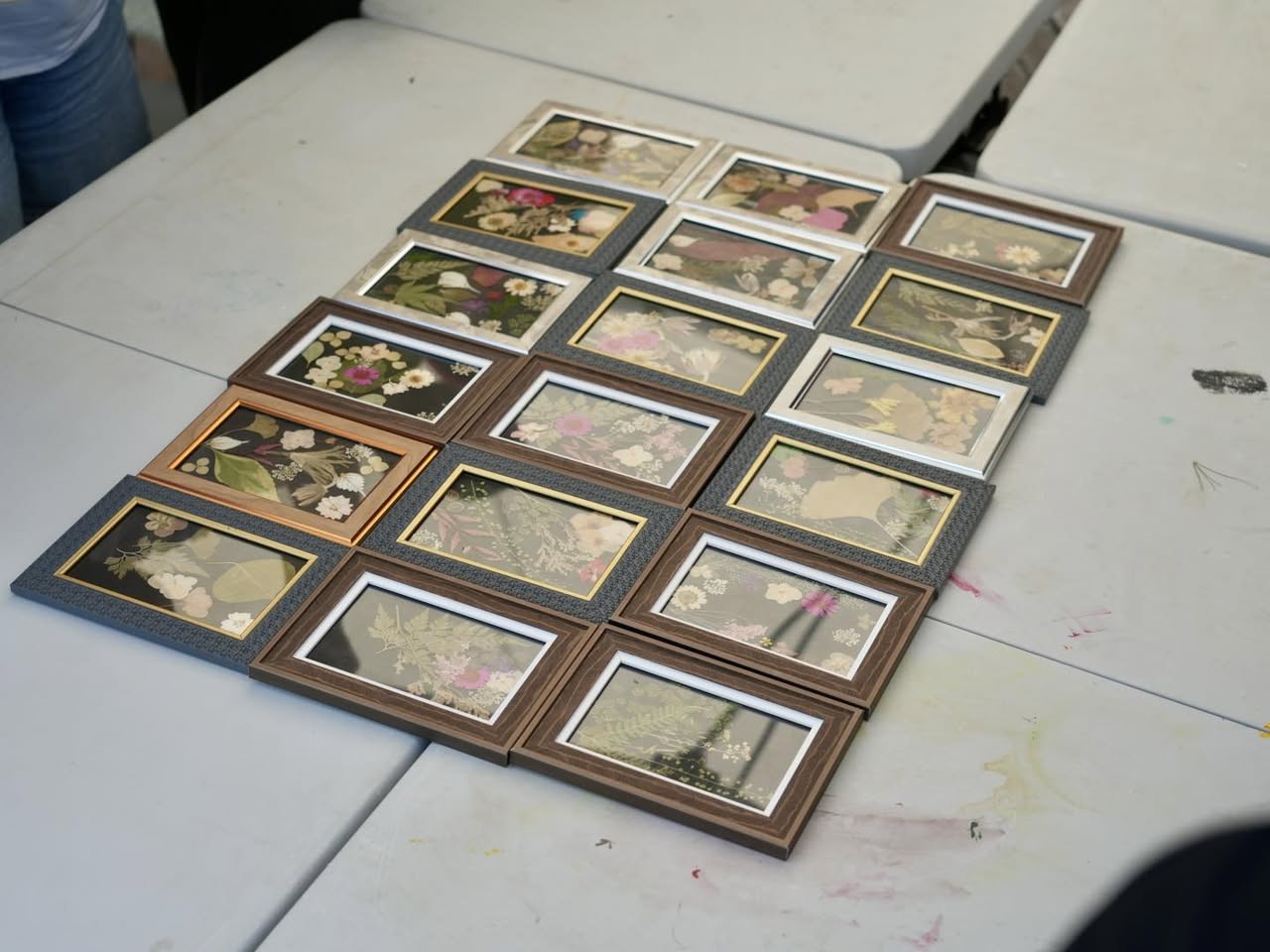 Participants engaged in the delicate process of flower pressing at the workshop.