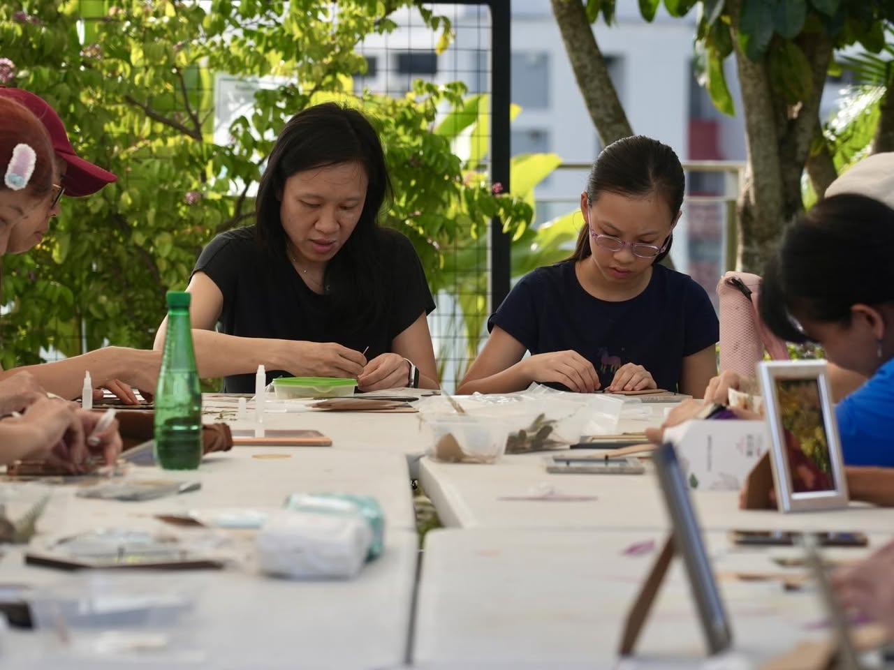 Attendees enjoying a serene sensory walk through the lush OTH Wellness Garden.