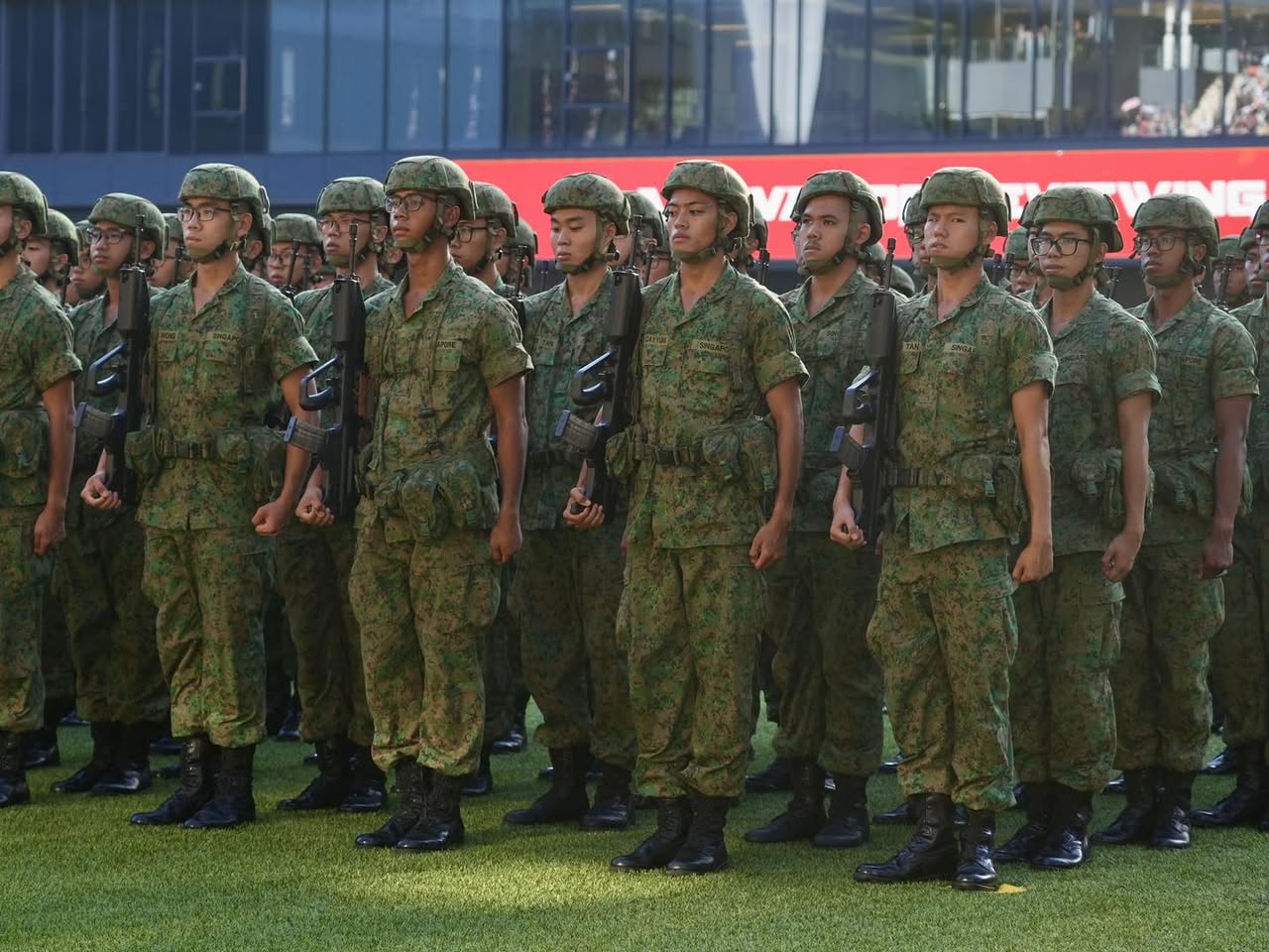 Parents and friends cheering enthusiastically from the audience.