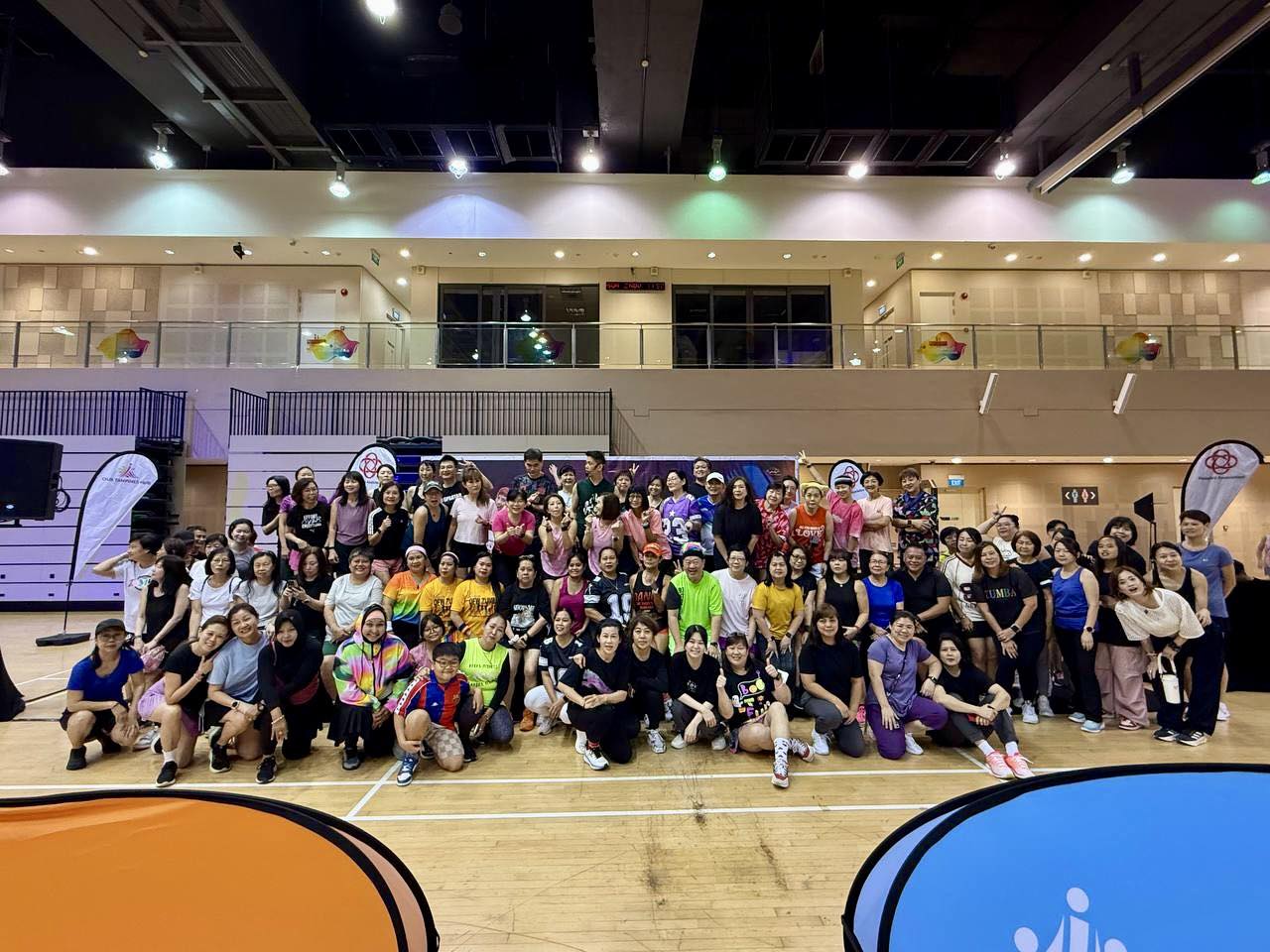 Energetic crowd following the instructors at the Cardio Dance Relay event