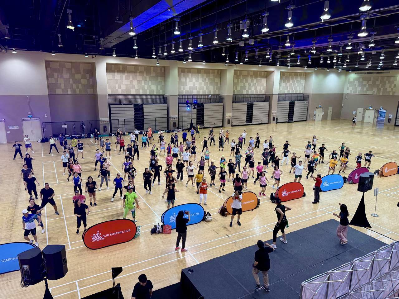 Instructors leading a dynamic dance routine at the Tampines West CSN event