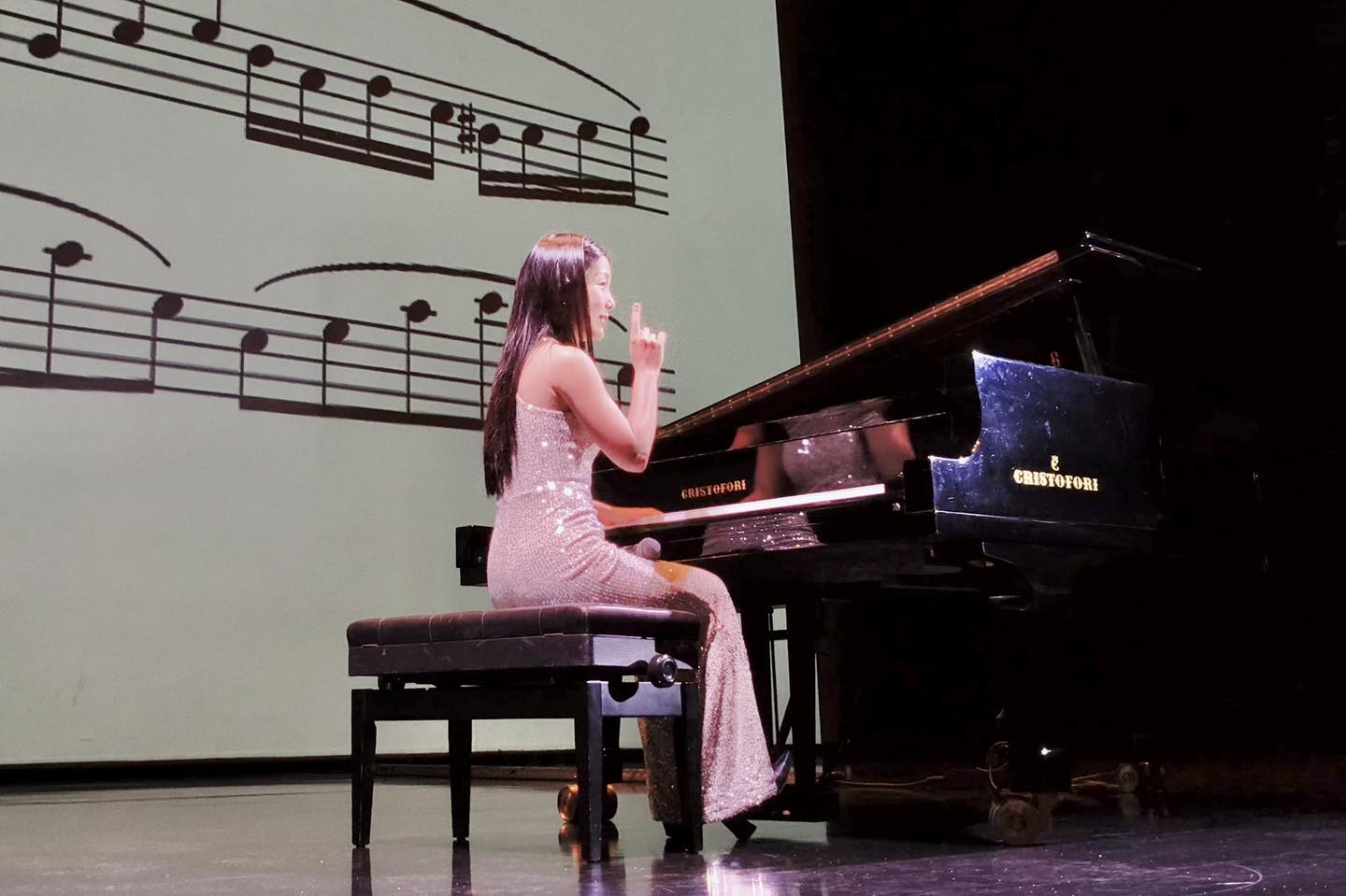 Audience members, including children, attentively watching a performance.