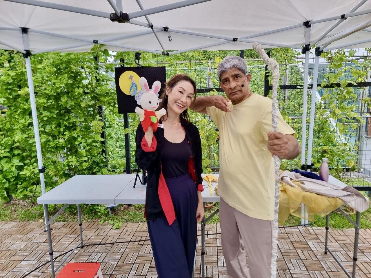 A storyteller engaging children and parents in the serene garden setting.