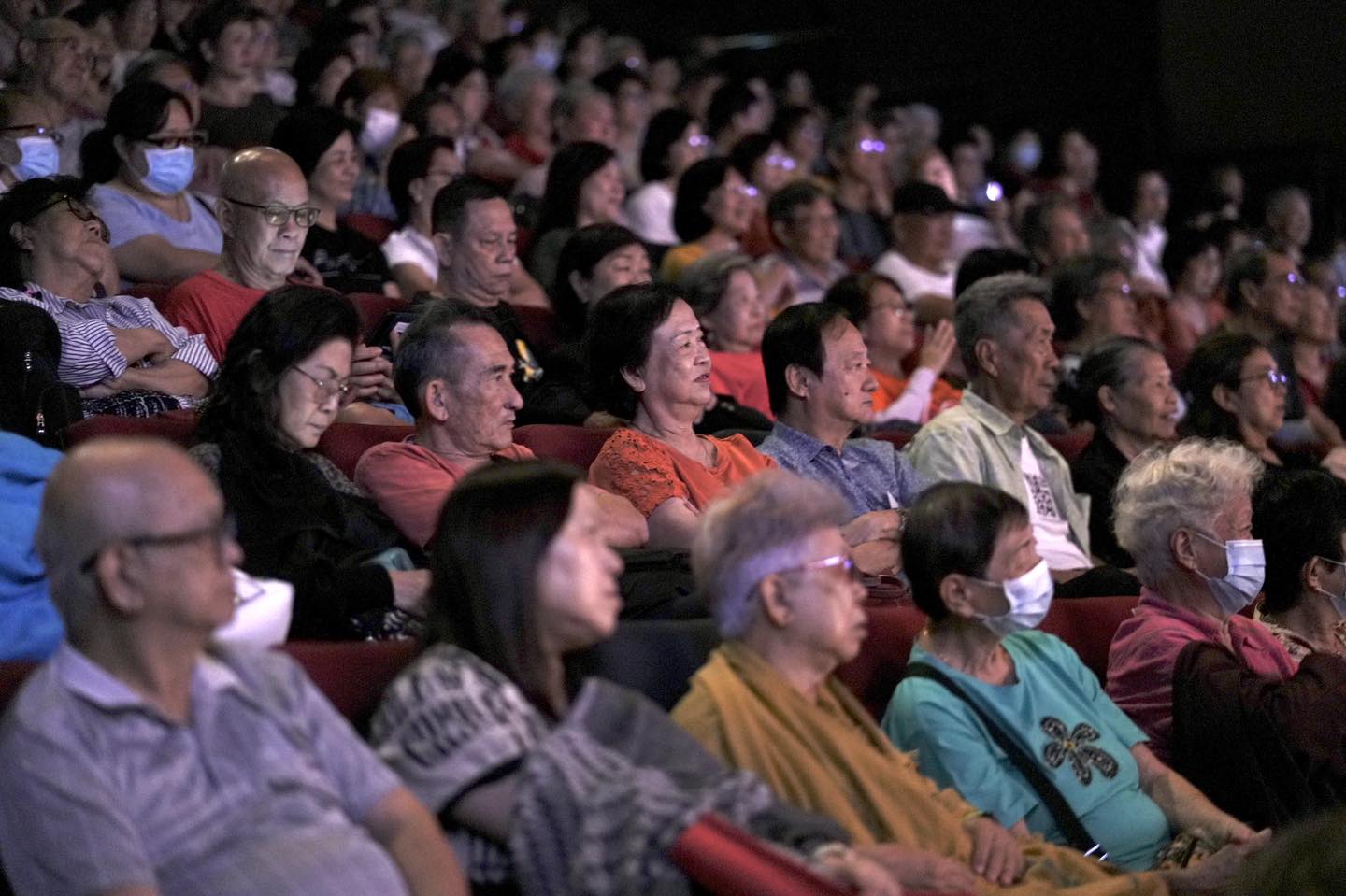 A close-up view of a vocalist passionately performing during the Fei Yu-ching tribute.