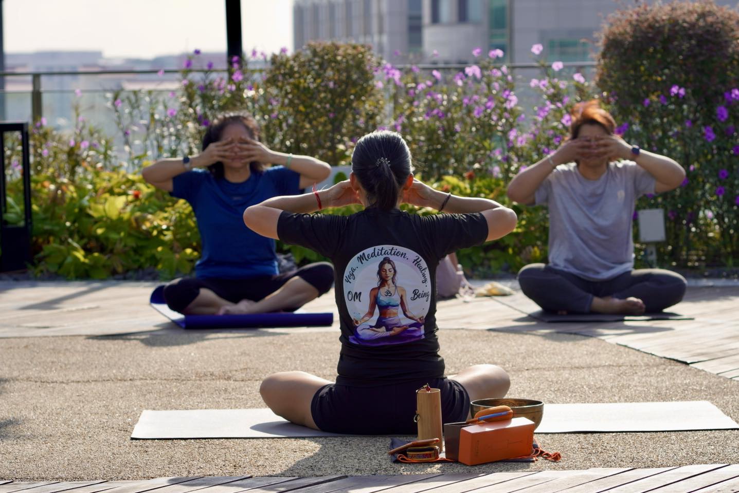 A group of people performing yoga poses under the morning sun.