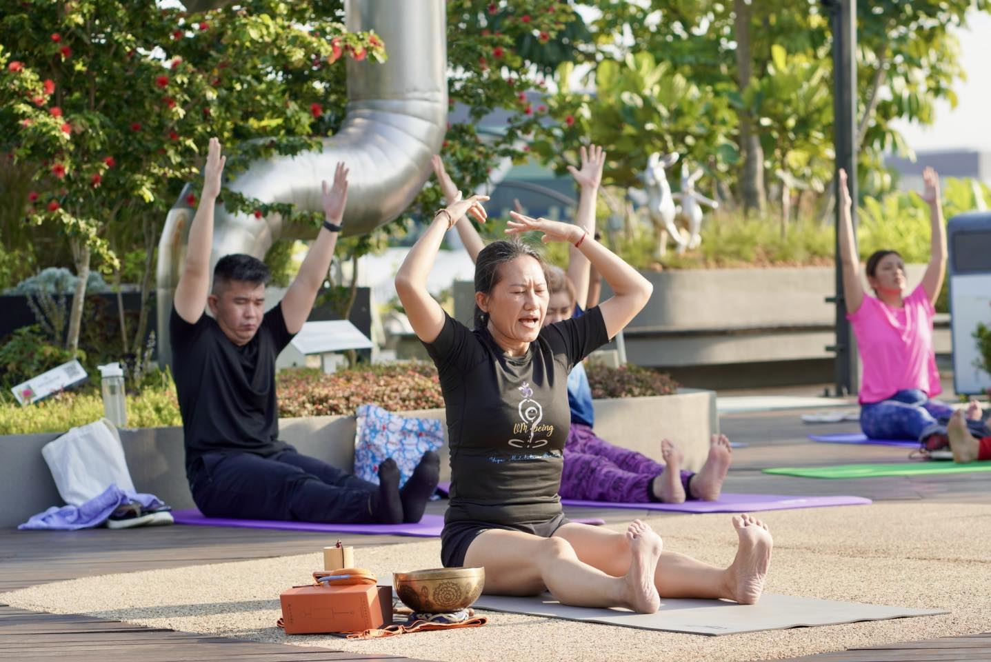 Attendees enjoying a moment of peace during an outdoor yoga class.