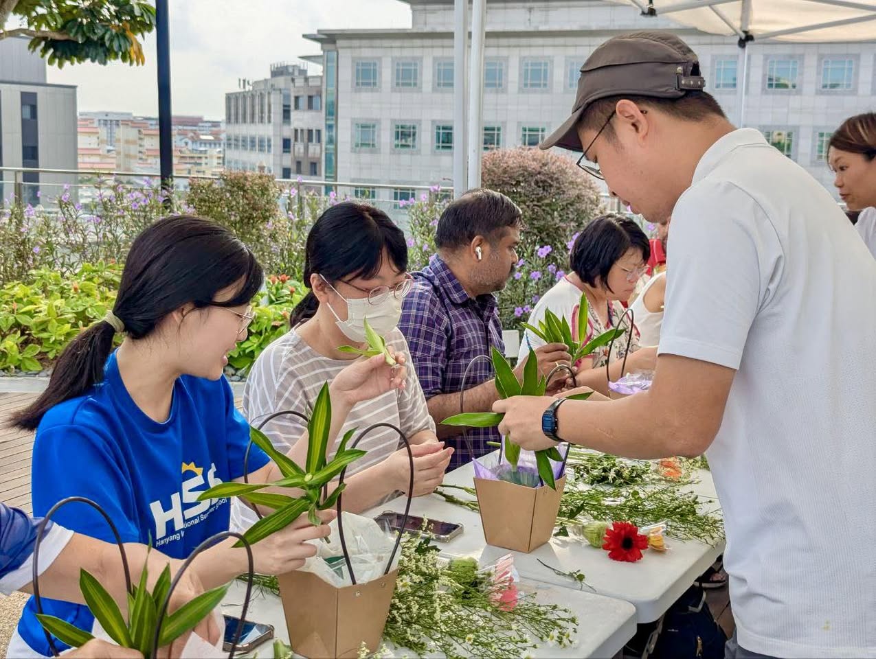 Attendees proudly showcasing their completed floral masterpieces