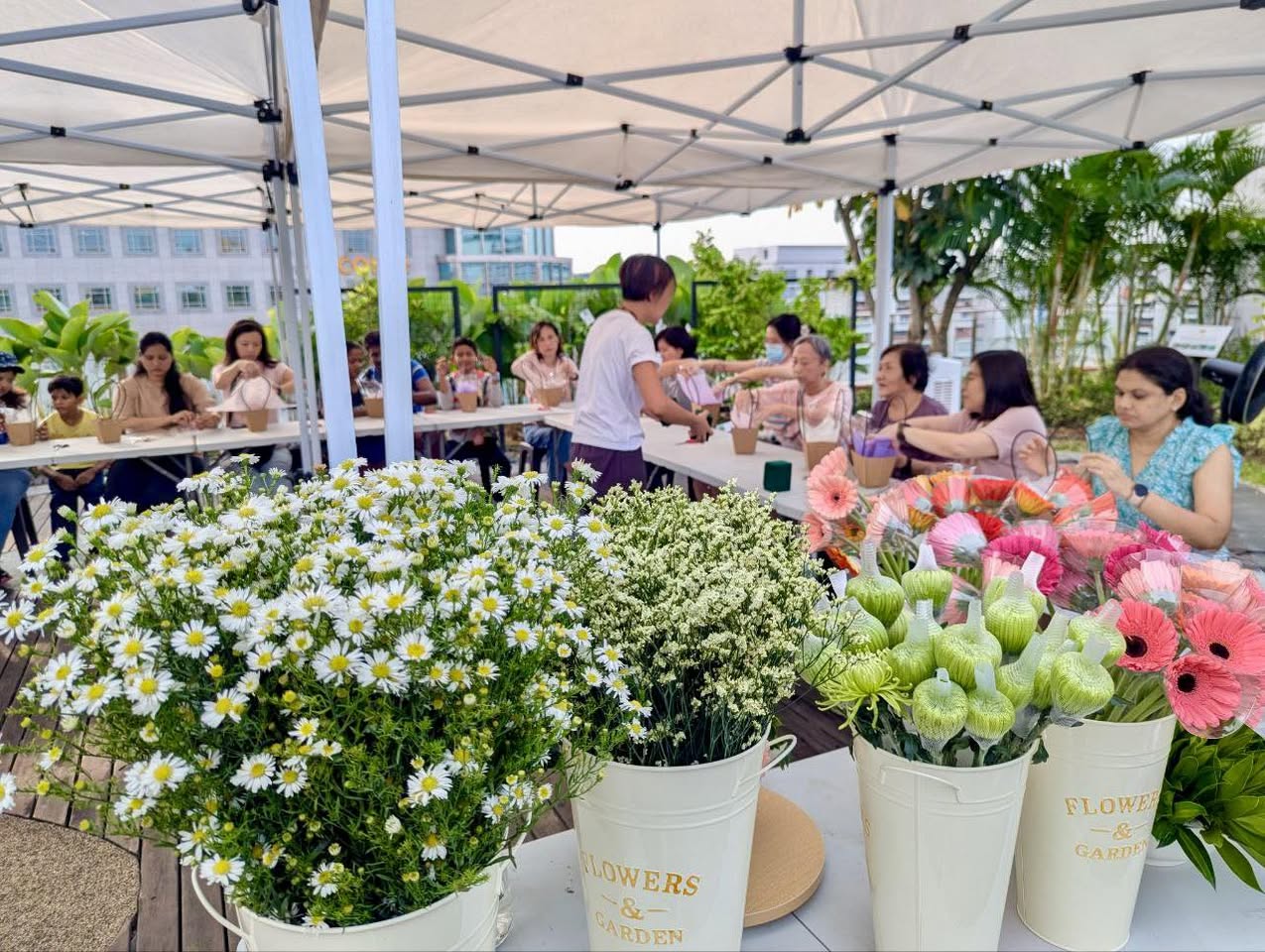 A vibrant assortment of flowers and greenery laid out for the workshop