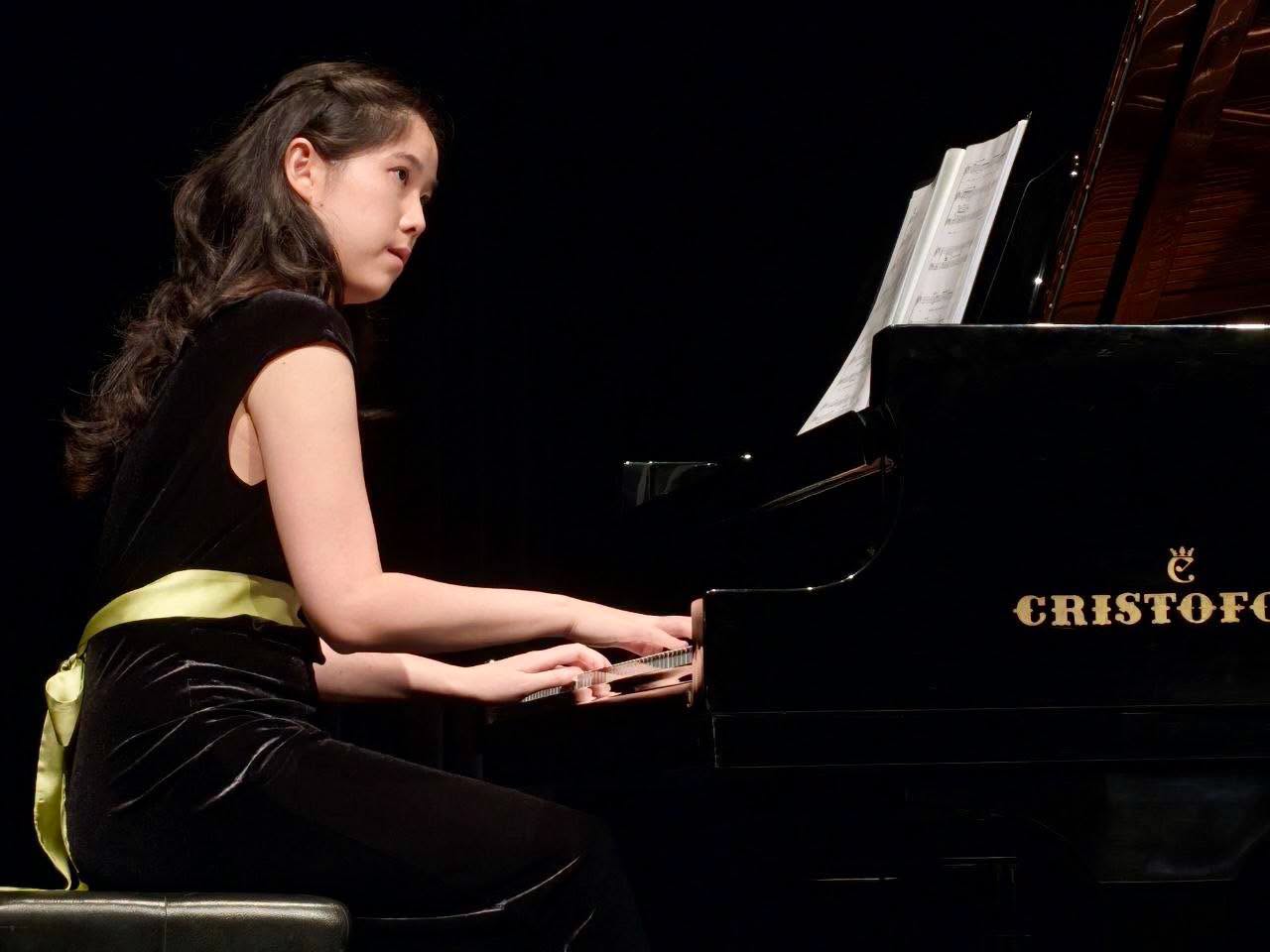 Young pianist performing on CRISTOFORI grand piano