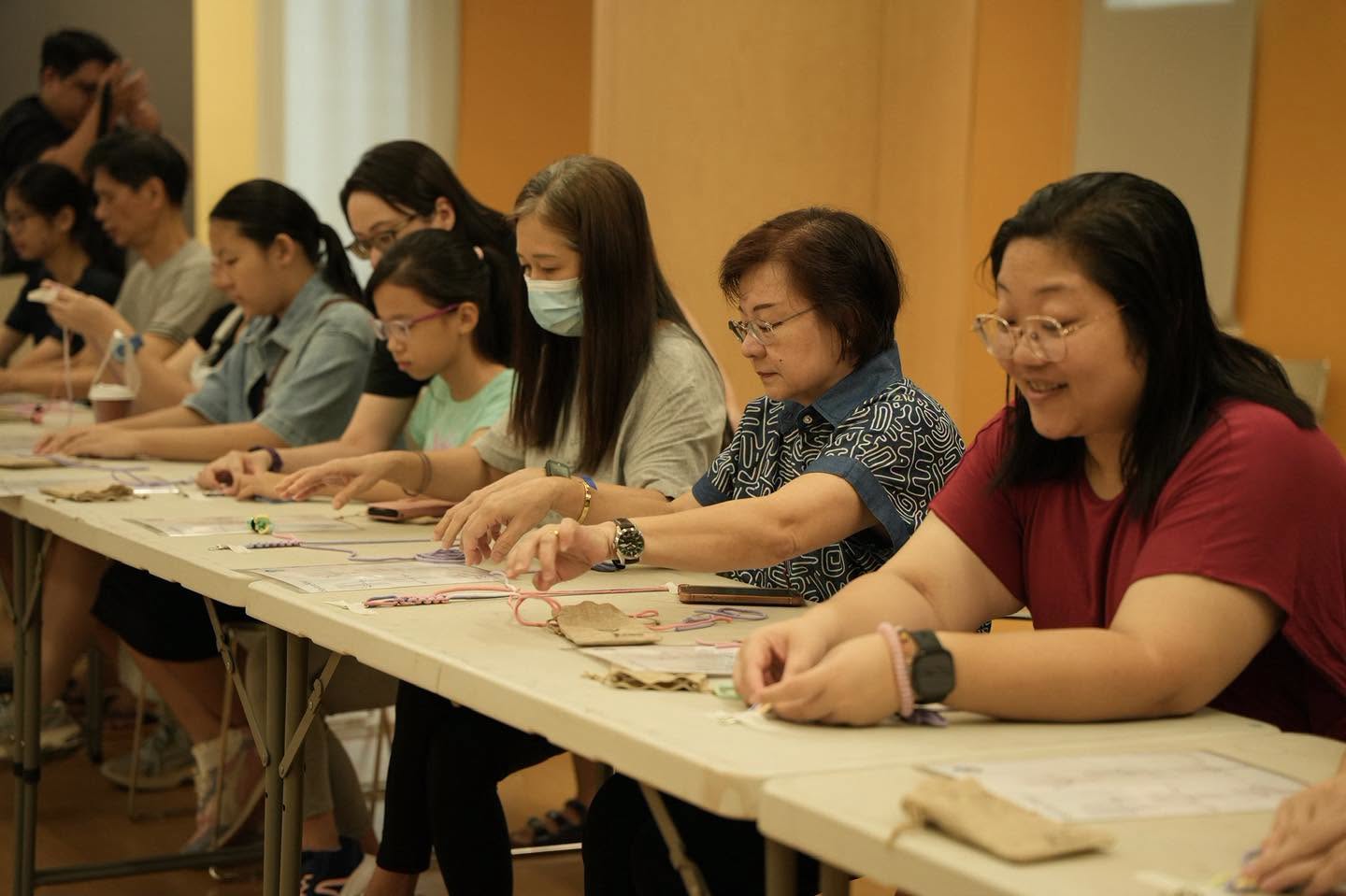 Participants at the Macrame Strap workshop crafting their wristlets