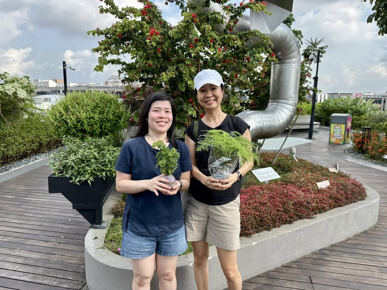 Workshop attendees proudly displaying their finished Kokedama creations