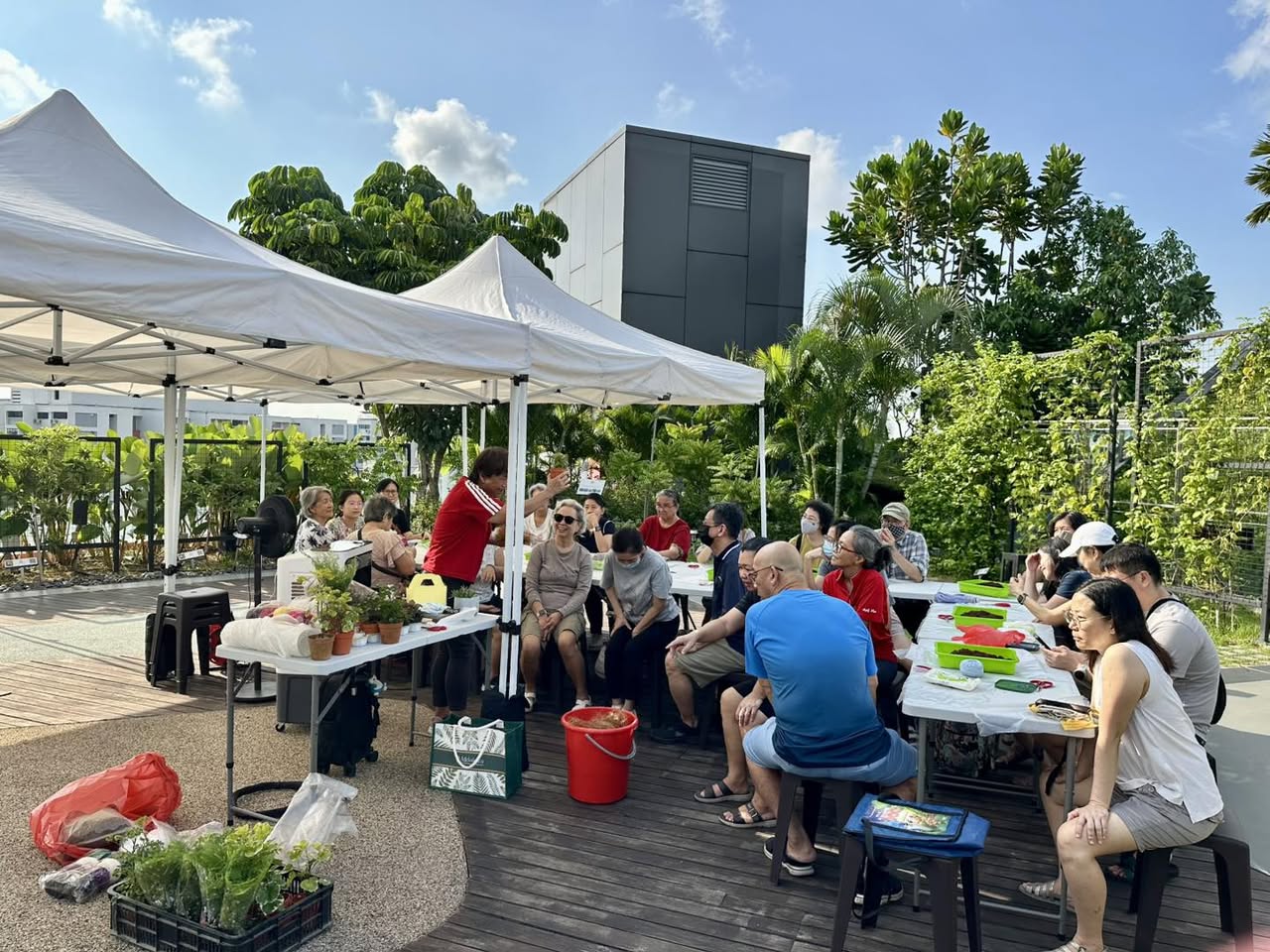 A close-up of hands wrapping plant roots for a Kokedama