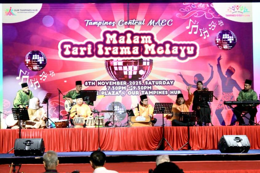 Attendees dressed in stunning traditional Malay costumes enjoying the festivities and cultural performances