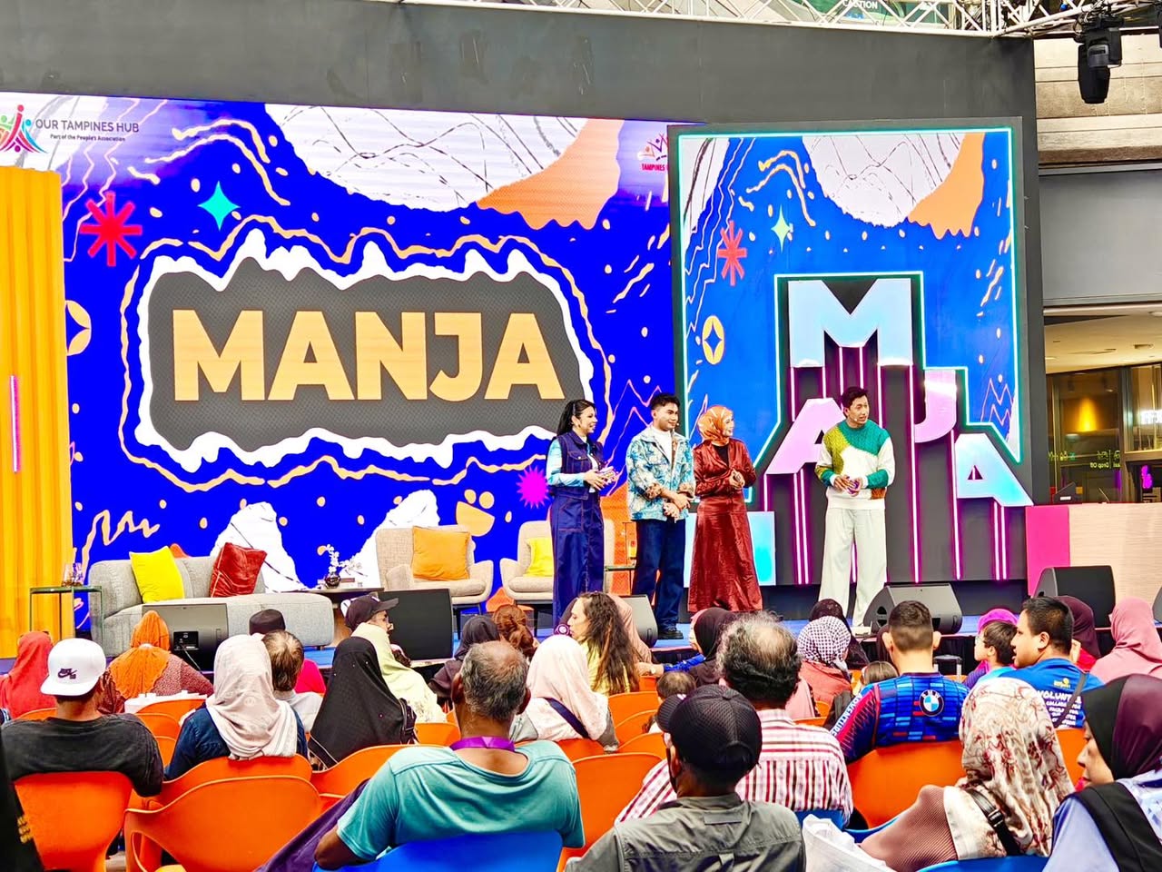 MANJA hosts on stage interacting with the audience