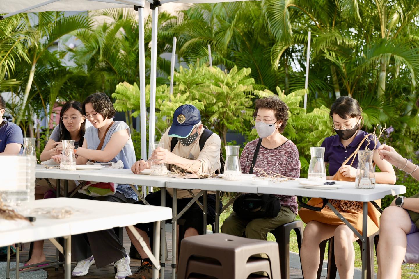 Participants actively engaged in crafting at the Marimo Moss Ball Terrarium Workshop.