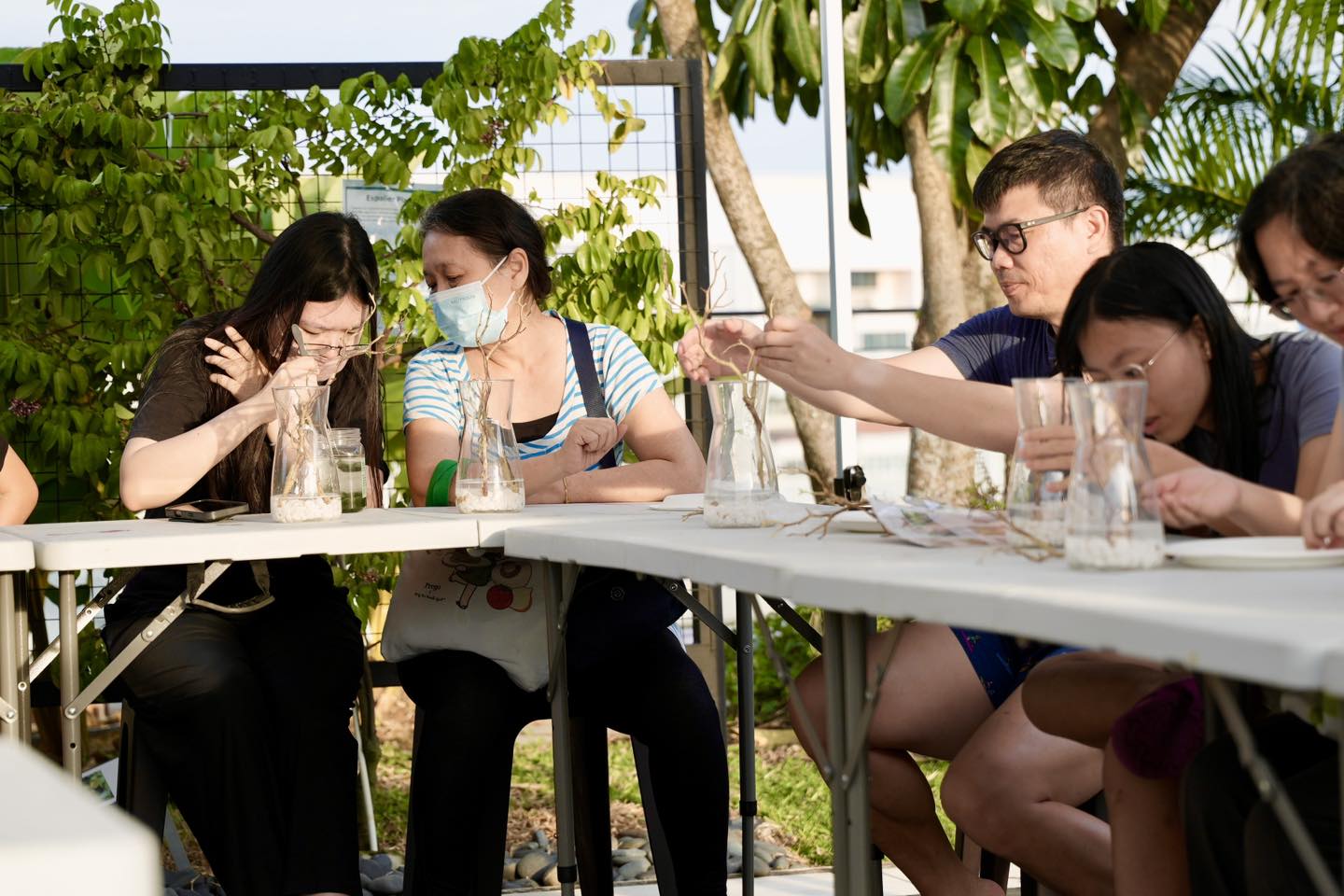 Attendees listening intently during a demonstration at the terrarium workshop.