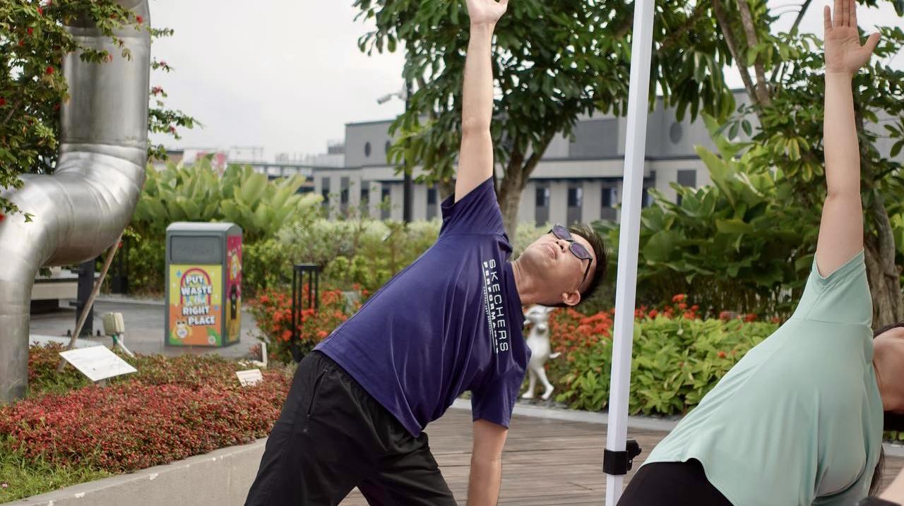 Participants engaged in a basic alignment yoga session outdoors.