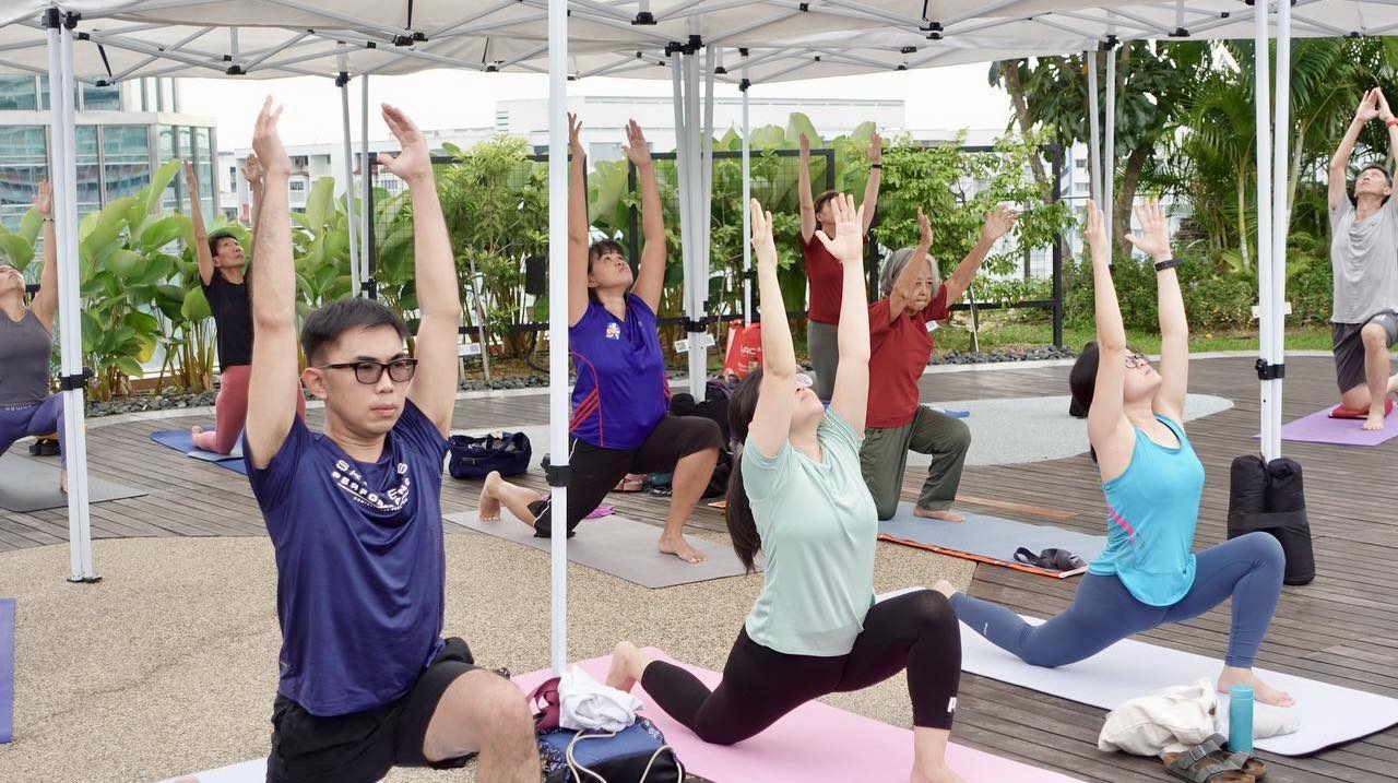 Individuals practicing yoga with focus and calm at the Wellness Garden.