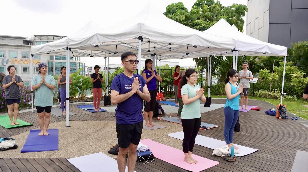 An aerial view of the outdoor yoga class at Wellness Garden, Level 5.