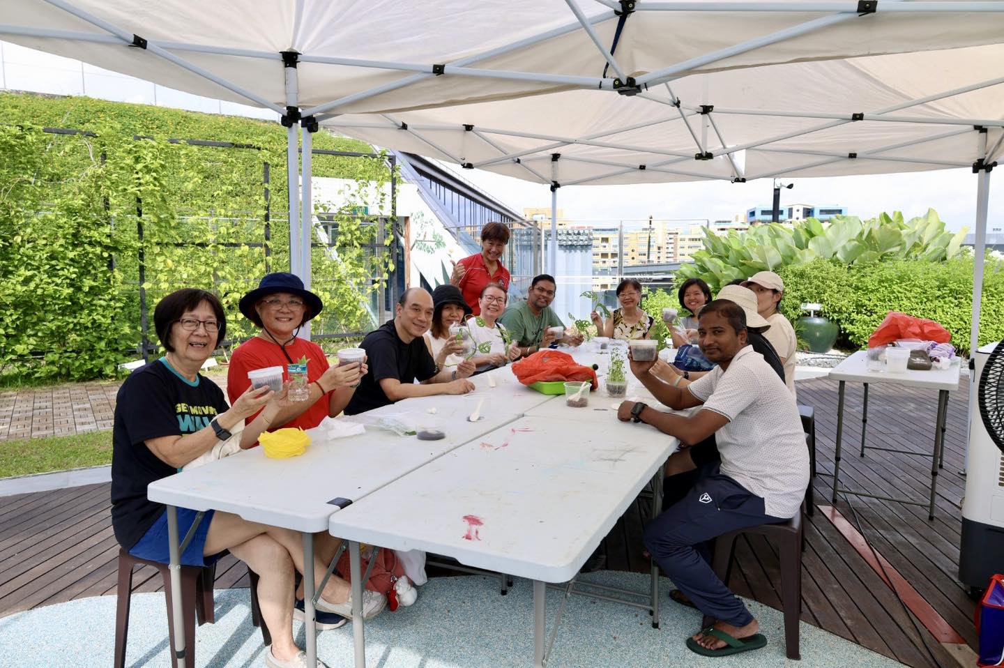 Families proudly displaying their baskets of harvested vegetables.