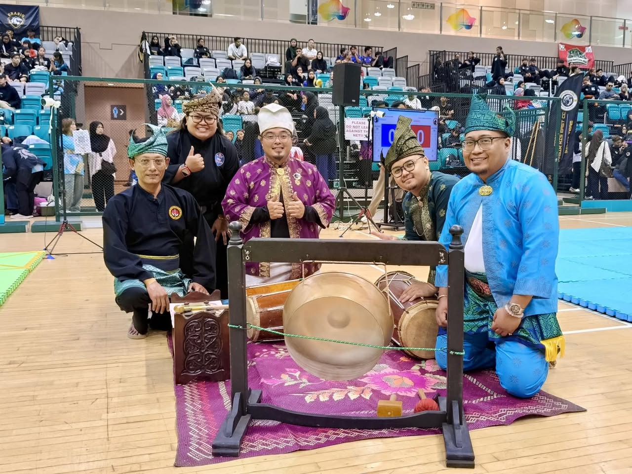 Audience members enthusiastically watching the Silat competition