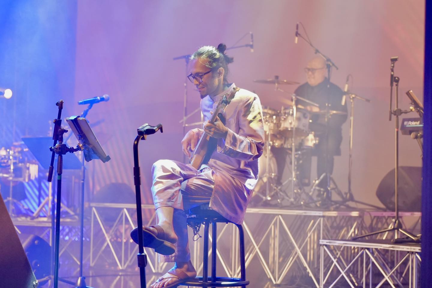 Close-up of a rock band member playing guitar during the concert