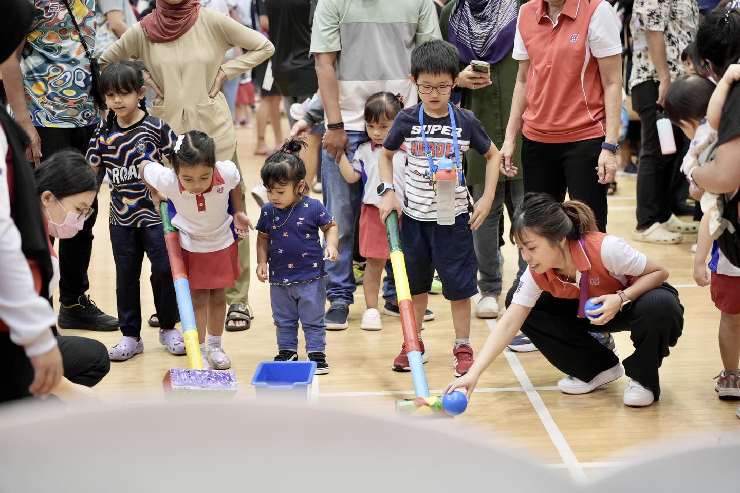A group of children and adults enjoying a playful moment at the PCF Sparkle Tots event