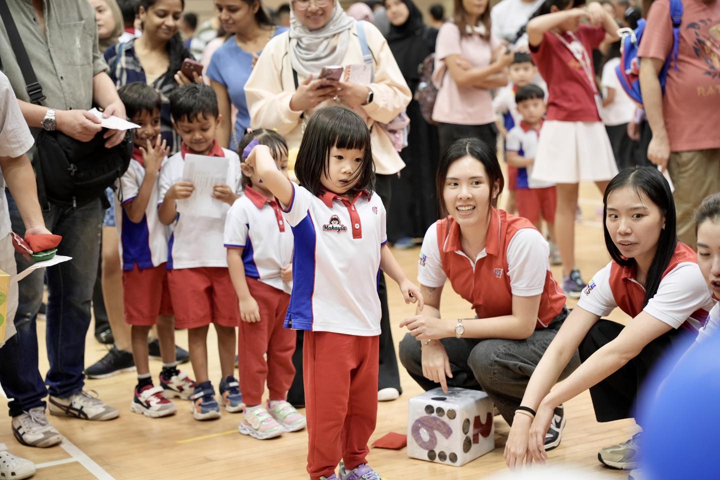 Excited children taking part in a race at the Our Tampines Hub auditorium
