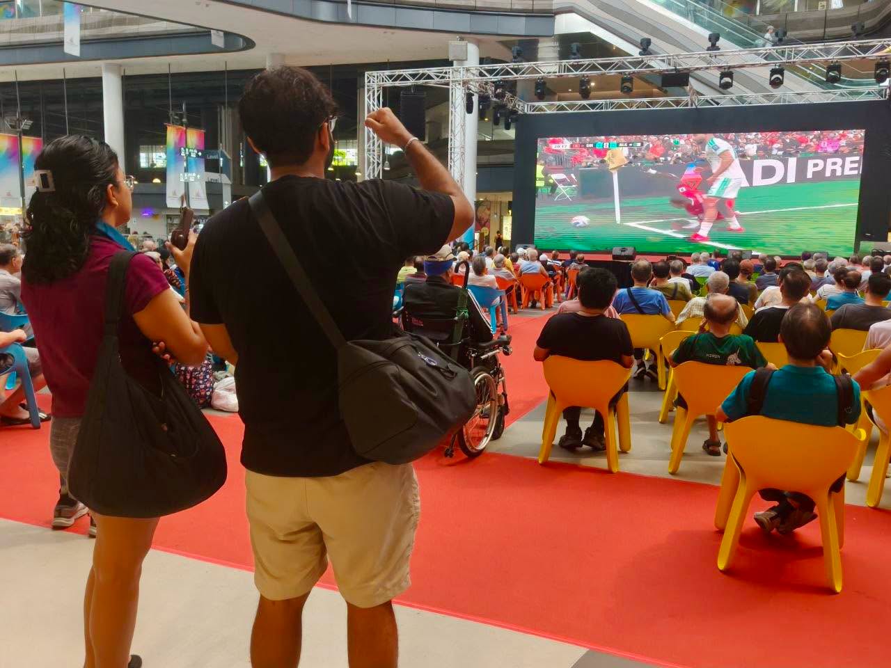 Live football broadcast on large screen at Our Tampines Hub