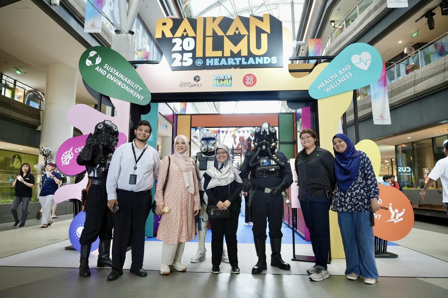 A lively scene at Raikan Ilmu event with people engaging in activities.