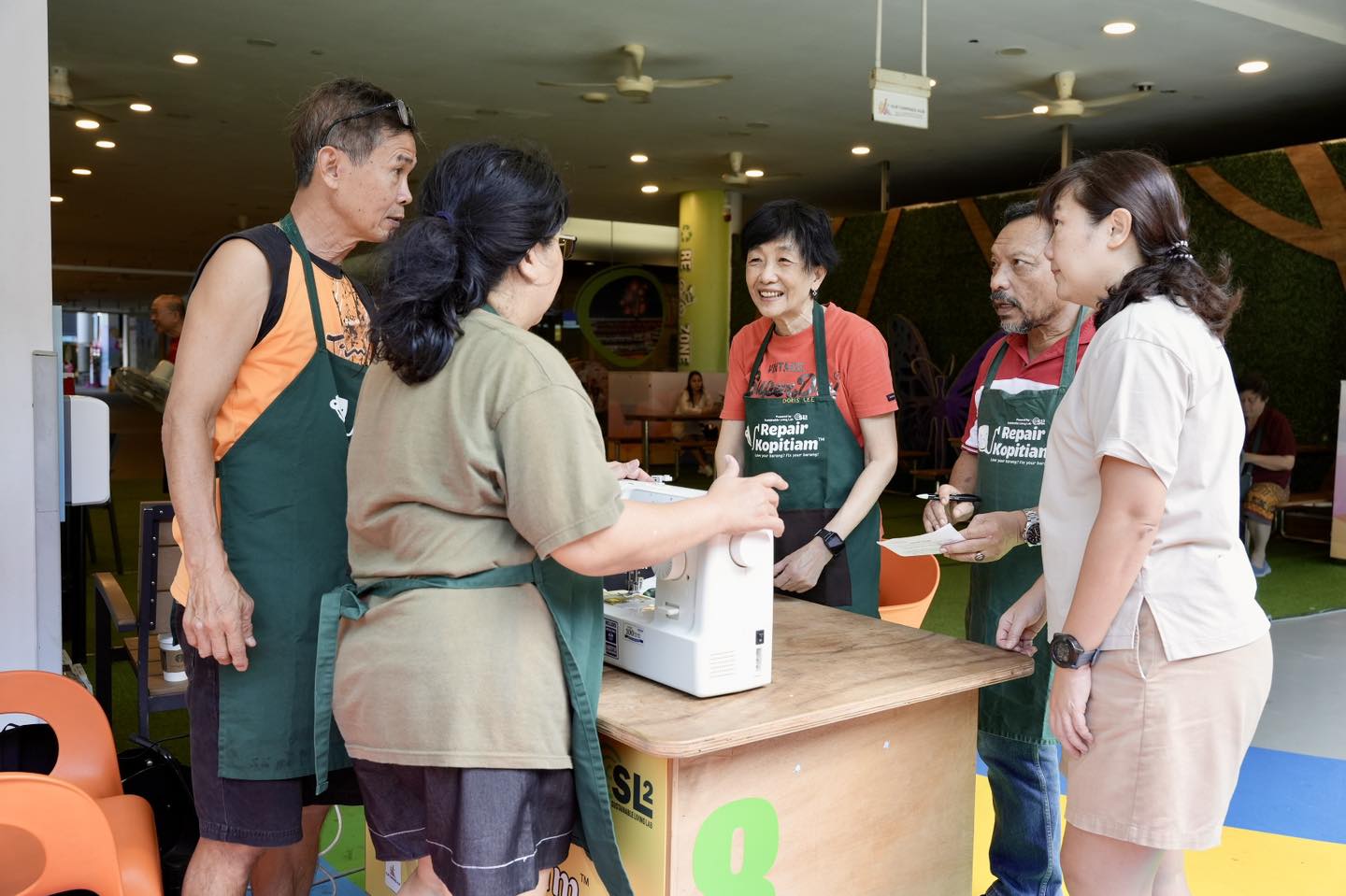 A resident learning to fix an item with guidance from a volunteer.