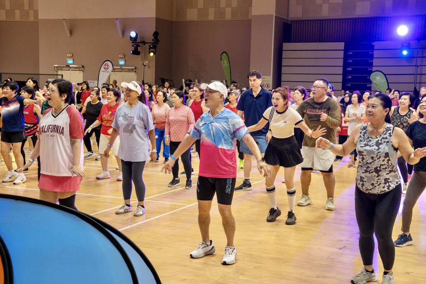 David SteadyAsia engaging the crowd in a dynamic fitness routine