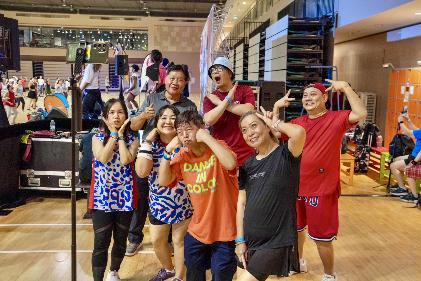 A large crowd actively participating in KpopX Fitness during the event