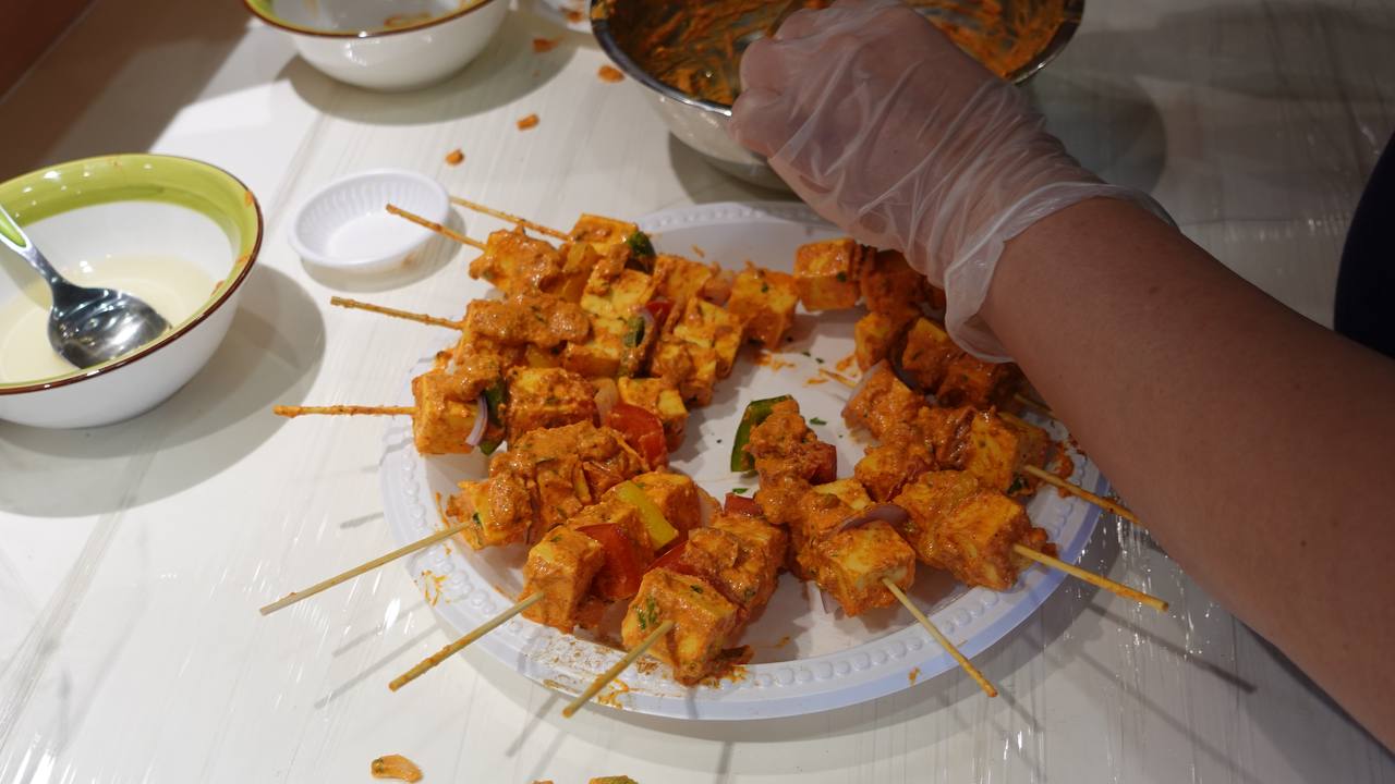 A vibrant display of finished paneer and chicken tikka dishes