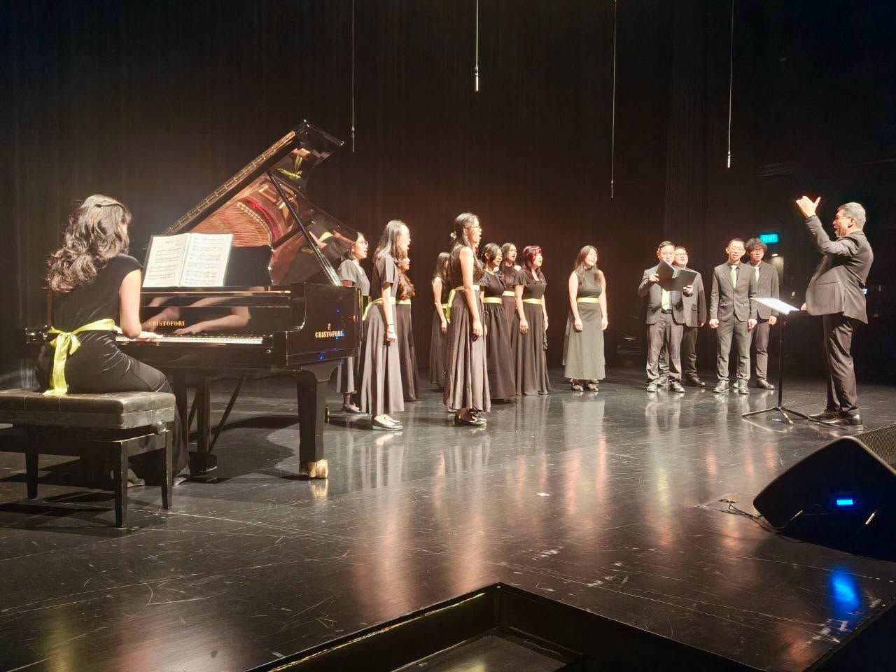 Choir and pianist performing at Festive Arts Theatre