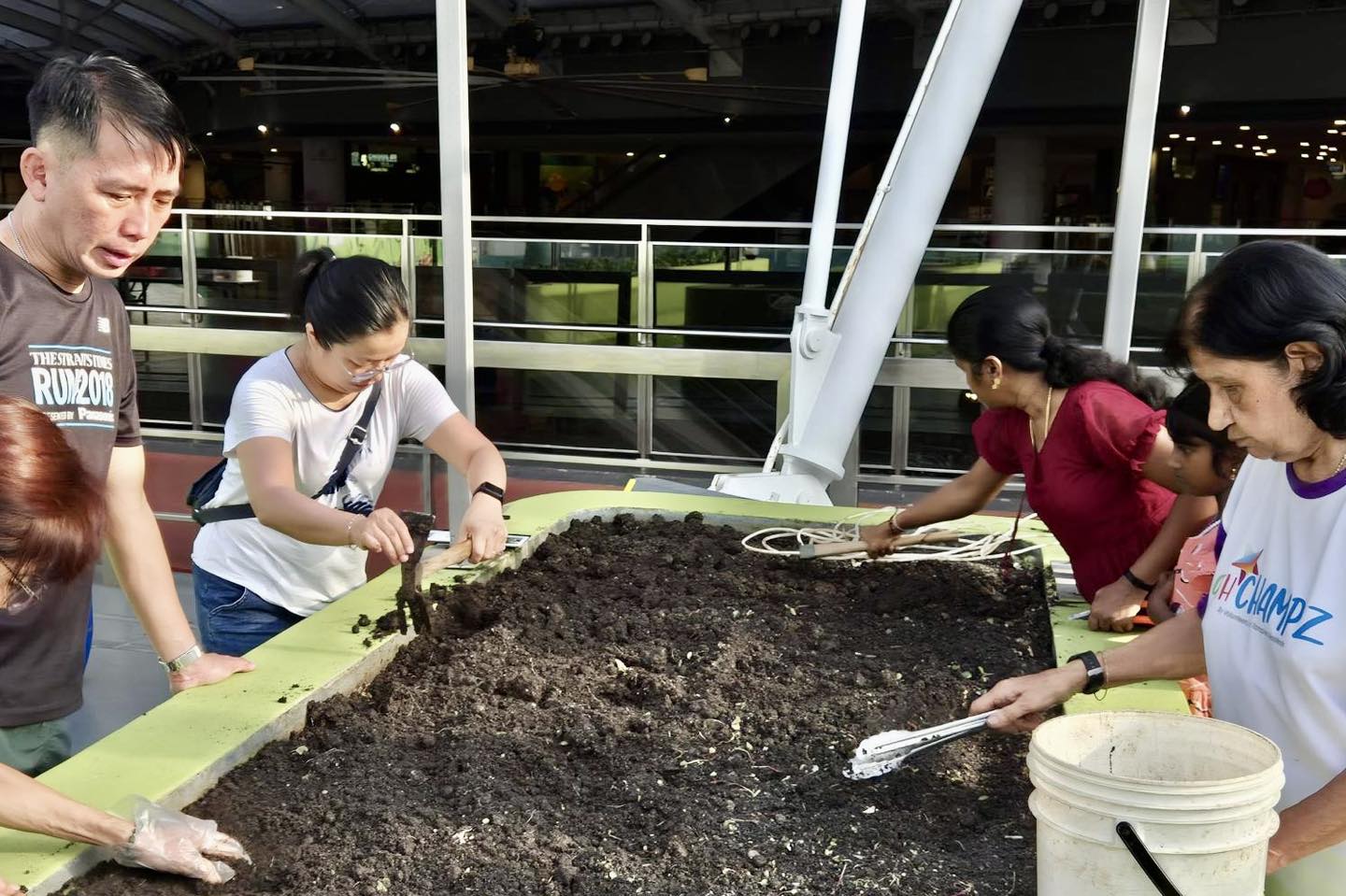 Tampines residents gathering at the OTH Eco-Community Garden for Harvest Day.