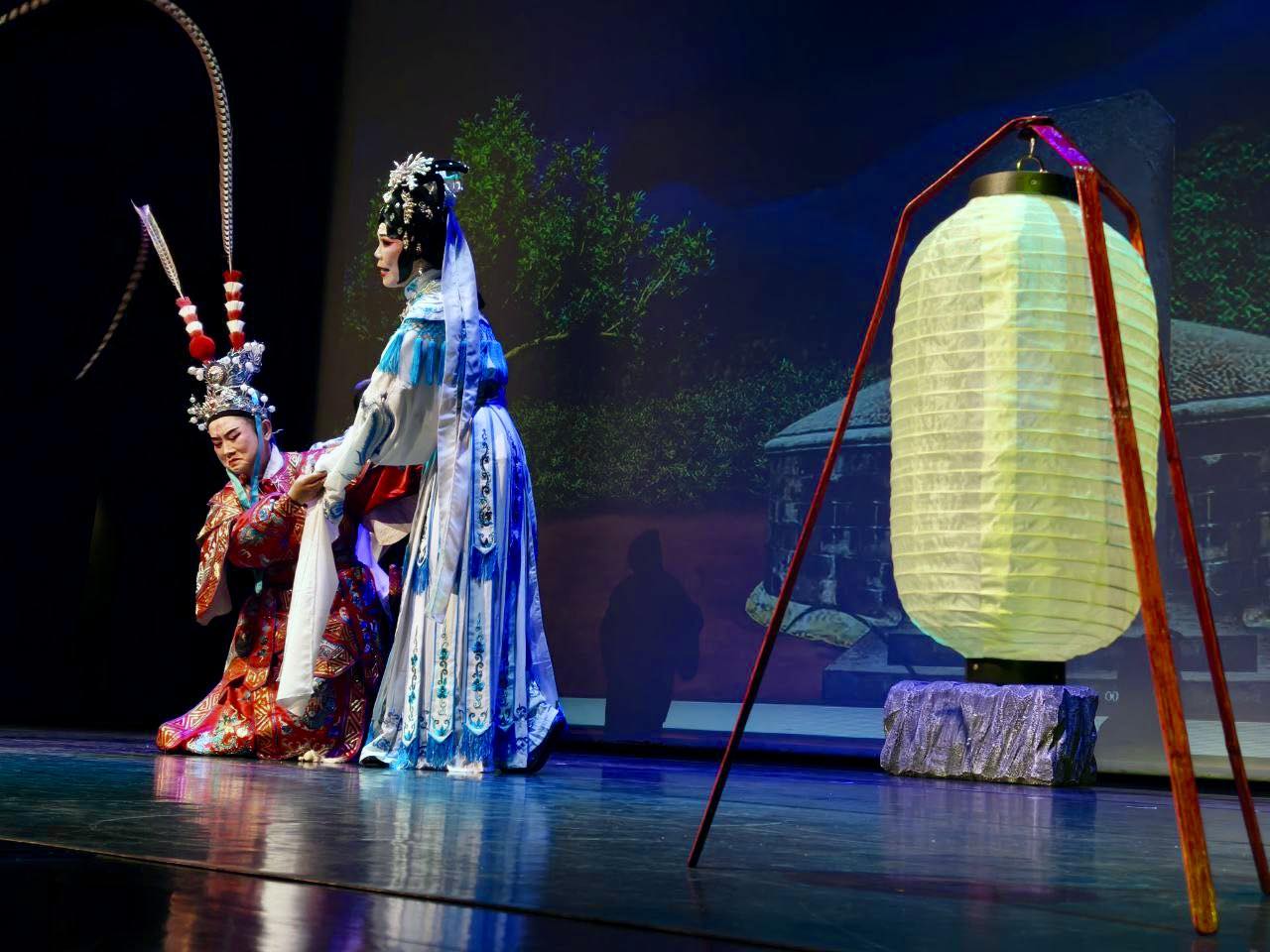 Teochew opera performers bowing gracefully to the audience on stage after a show.