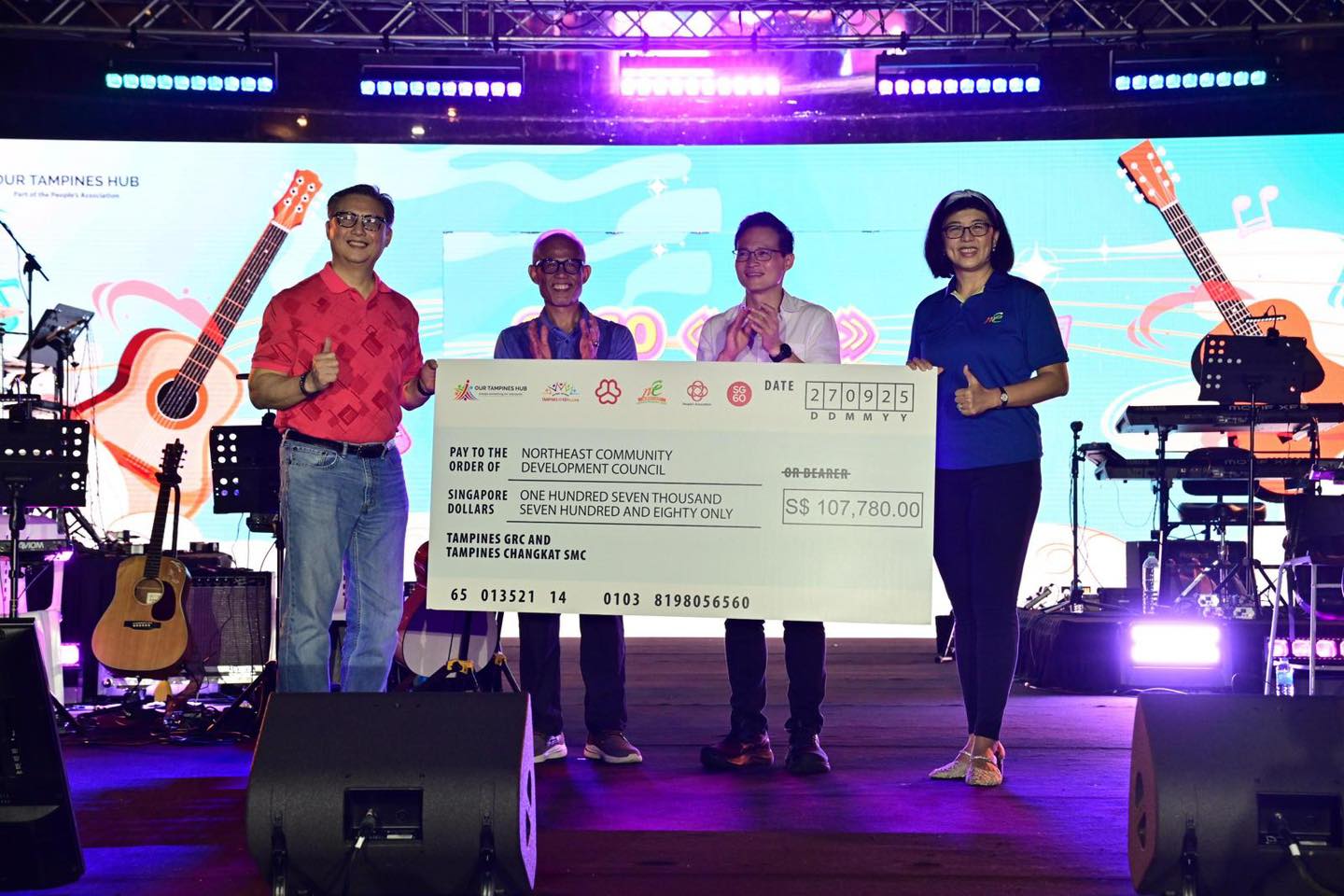 Distinguished guests on stage for a special cheque presentation