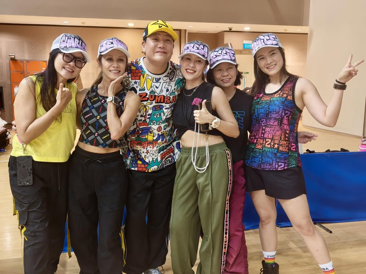 Zumba instructors on stage, engaging with the audience.